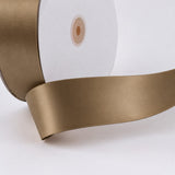 Gold satin ribbon roll close-up on white background