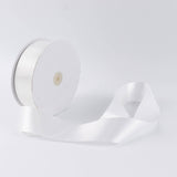 White satin ribbon roll on a spool, isolated on a white background