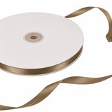 White satin ribbon roll with gold edge on a spool, isolated on white#whtbkgd