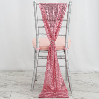 Pink sequin chair sash draped elegantly over a silver chiavari chair.