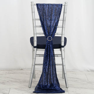 Navy sequin chair sash with a decorative ring on a silver chair