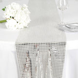 Silver sequin table runner draping elegantly over a table. #whtbkgd