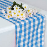 Blue checkered table runner with white daisies centerpiece