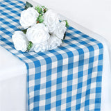 Blue and white checkered table runner with white rose bouquet centerpiece