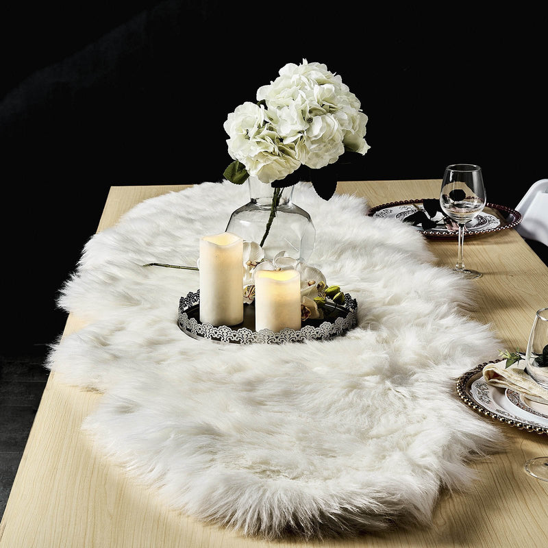 White sheepskin runner on a dining table with flowers and candles