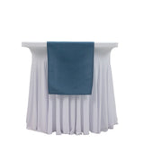 Blue table cloth draped over a white table skirt