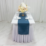 Elegant table setting with floral centerpiece and blue table runner.