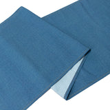 Denim fabric with contrasting inner lining, folded neatly.