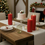 Festive holiday dining table with candles, cake, and decorations.