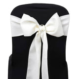White satin chair sash tied in a bow on a white chair. #whtbkgd