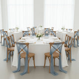 Elegant dining setup with blue and white decor and floral centerpieces.