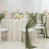 Elegant wedding reception setup with white tables, green accents, and floral centerpieces.