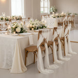 Elegant wedding reception table adorned with flowers and candles.