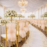Elegant white and gold wedding reception with floral centerpieces and aisle decor