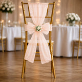 Gold wedding chair with blush tulle bow and floral centerpiece
