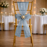 Gold wedding chair with blue tulle bow and floral centerpiece
