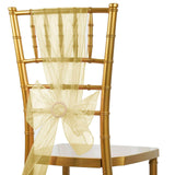 Gold chiavari chair with sheer yellow sash and bow on a white background.