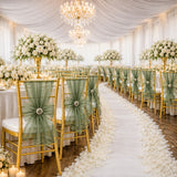 Elegant wedding reception with white roses, gold chairs, and green bows on aisle