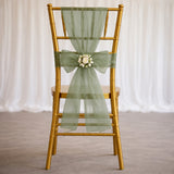 Gold chiavari chair with sage green sheer sash and floral centerpiece