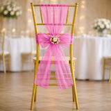 Gold wedding chair with pink tulle bow and floral centerpiece decoration