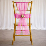 Gold chiavari chair with pink bow and floral centerpiece for wedding decor