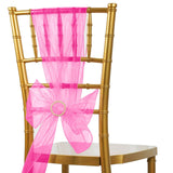 Gold chiavari chair with a pink organza sash and bow.