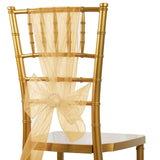 Gold chiavari chair with elegant sheer gold sash and bow.