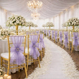 Elegant wedding reception with lavender chairs, white roses, and chandeliers