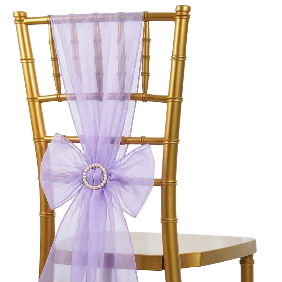 Gold chiavari chair with lavender sheer bow sash and pearl centerpiece