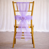 Gold chiavari chair with a lavender organza bow and flower detail.