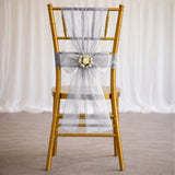 Gold chiavari chair with silver sheer wedding bow and floral centerpiece