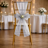 Gold wedding chair with white tulle and floral bow decoration