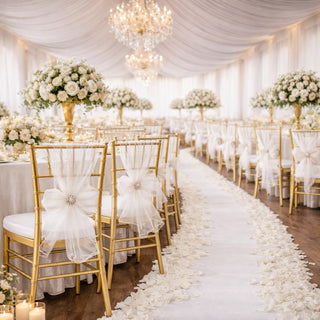 Elegant wedding reception with gold chairs, floral centerpieces, and soft lighting.