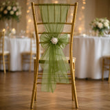 Gold chiavari chair with green tulle sash and floral accent in elegant event setting.