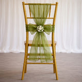 Gold chiavari chair with green ribbon and floral embellishment.