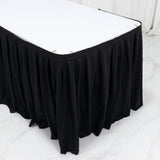 Black pleated table skirt with white tabletop in modern event setup