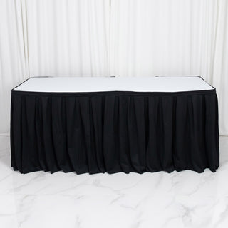 Black table skirt with white tabletop against white studio backdrop