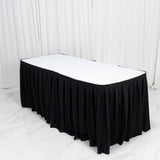 Black pleated banquet table skirt with white tabletop in event setup