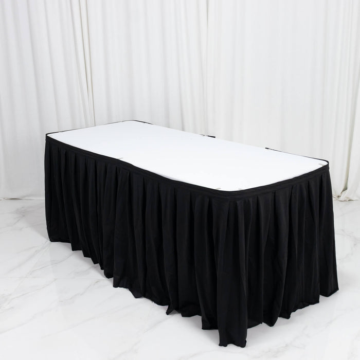 Black pleated banquet table skirt with white tabletop in event setup