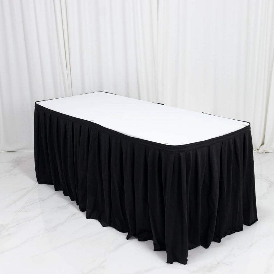 Black pleated banquet table skirt with white tabletop in event setup