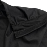 Black ribbed fabric close-up with stitched seam and velcro strip