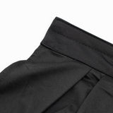 Black ribbed fabric waistband close-up detail on white background