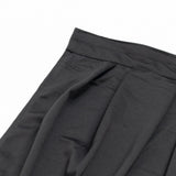 Black pleated fabric skirt waistband close-up on white background