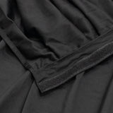 Black fabric close-up with velcro strap and stitched seam texture
