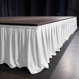 Stage platform with white draped skirt in an event venue