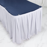 White banquet table with navy tablecloth and pleated skirt