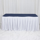 White fitted tablecloth with navy table cover for event display table