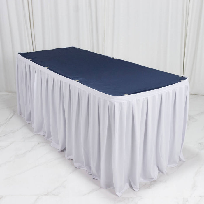 White banquet table skirt with navy tabletop cover on a rectangular event table