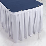 White banquet table skirt with navy blue tabletop cover on a round table