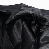 Black satin fabric close-up with soft folds and a glossy texture